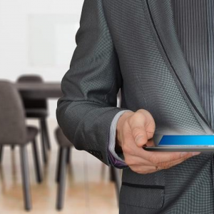 man holding a laptop planning an event after a pandemic