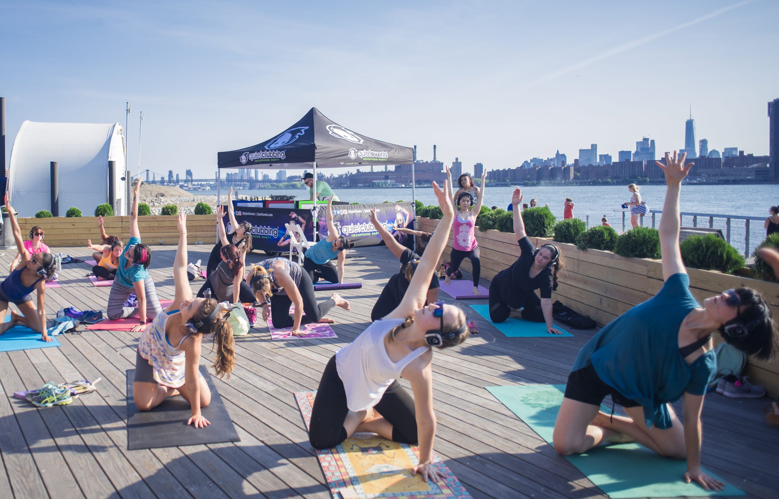 Yoga fitness class outside on a dock